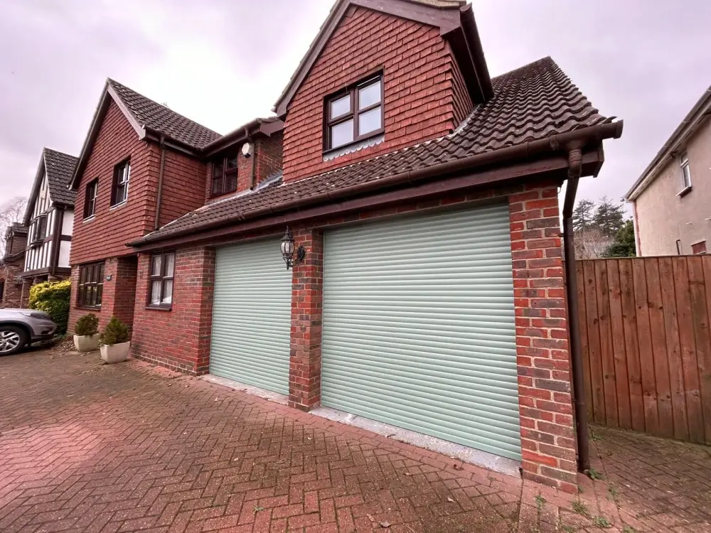 Insulated electric roller garage door in a soft heritage green finish