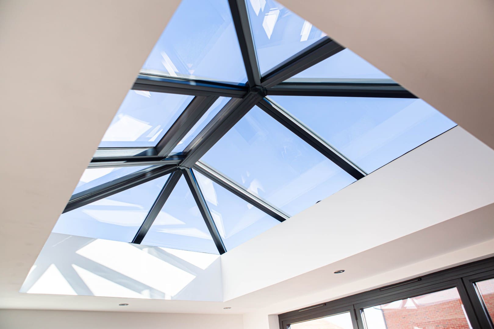 Contemporary flat roof with a large aluminium roof lantern above an open-plan living space