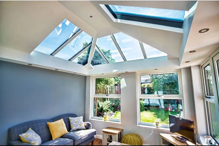 Glazed roof lantern above a conservatory living room with a grey sofa and garden windows, Faringdon