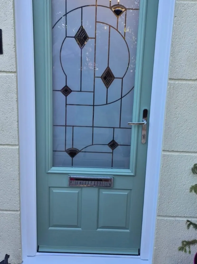 Chartwell green composite front door with Art Deco leaded glass in a cream stone wall, Cheltenham