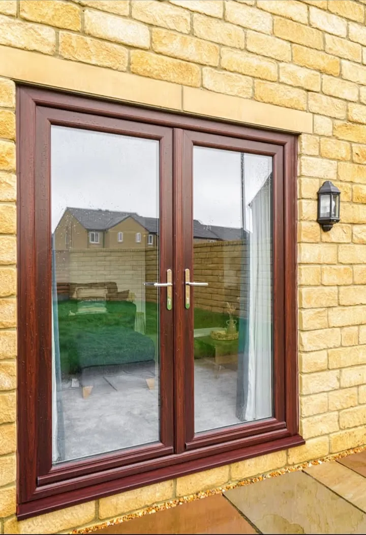 Rosewood French doors with a garden view, set in a Cotswold stone wall, Blunsdon