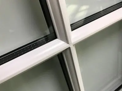 Close-up of astragal glazing bars meeting on a white sash window