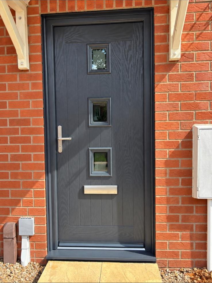 Anthracite grey composite front door with three square glazed apertures in Trowbridge, Wiltshire