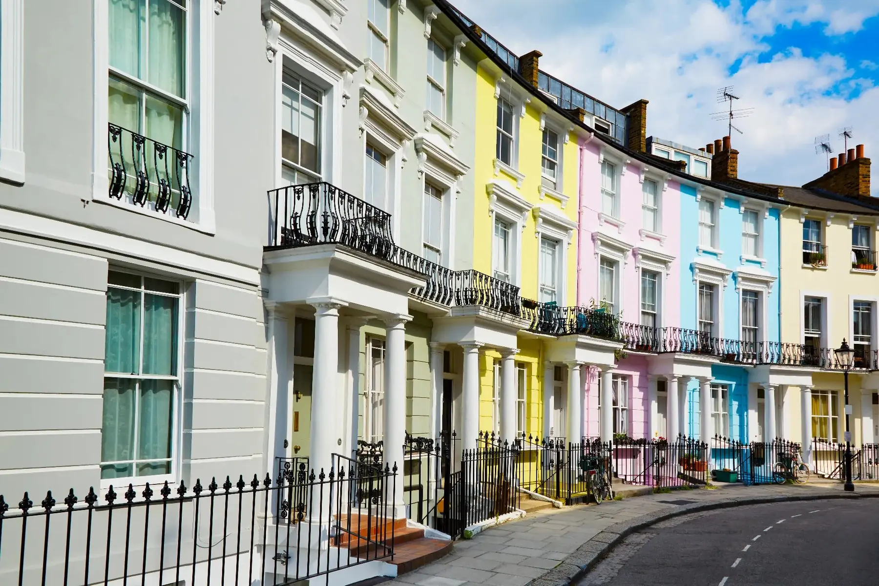Terrace of pastel-painted period houses with sliding sash windows