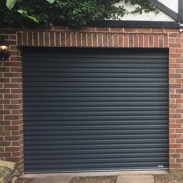 Anthracite insulated roller door in a red-brick opening beneath a Tudor-style gable