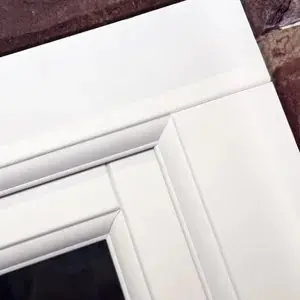 Close-up of a timber-look straight joint on a white sash corner