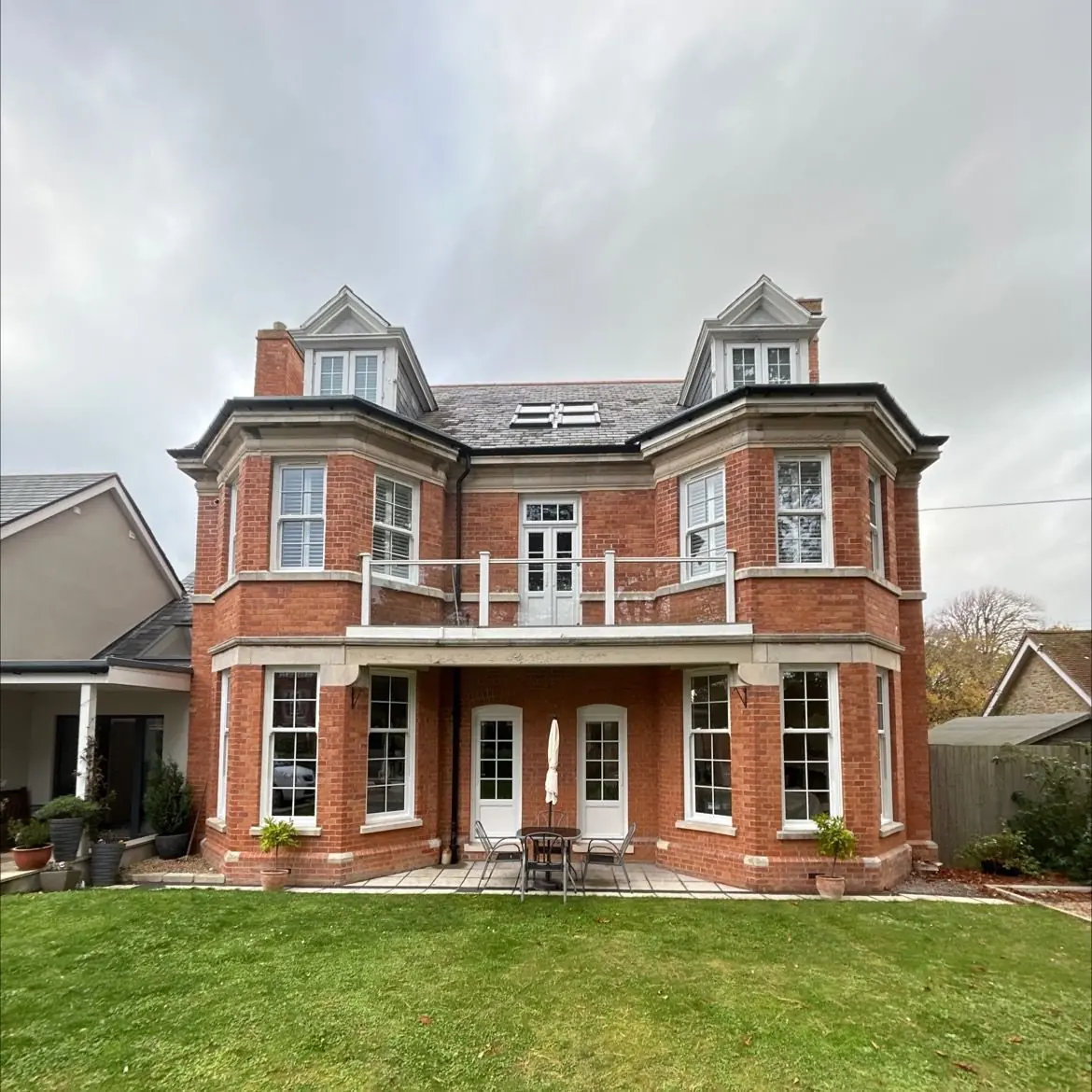 Large Victorian red brick villa with white sliding sash windows